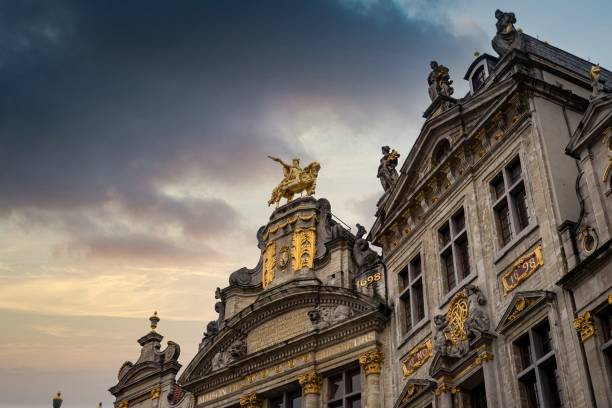 istock Low angle view of stony building facade with golden statue in Brussels 1446842455