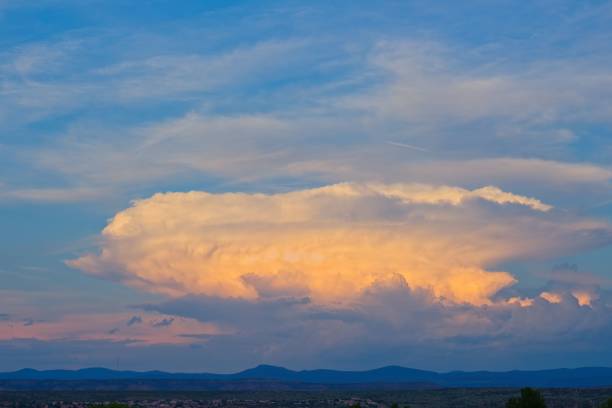 istock Giant white and orange storm cloud at sunset 1446842799