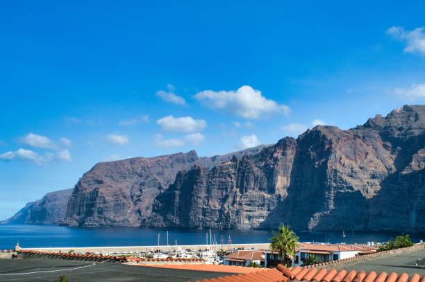 istock Rocky cliff in the sea with on a cloudy blue sky 1446842847