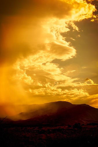 Sepia image of storm clouds over the mountains.