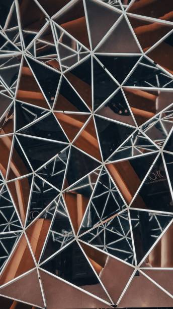 istock Vertical shot of a reflecting surface with glass triangles 1446842998