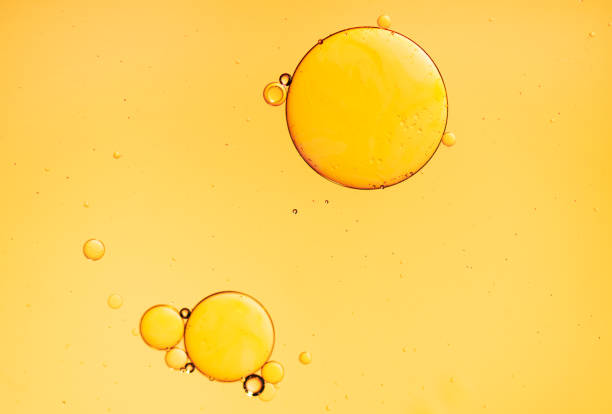 istock Golden yellow abstract oil bubbles or face serum background. 1446843583