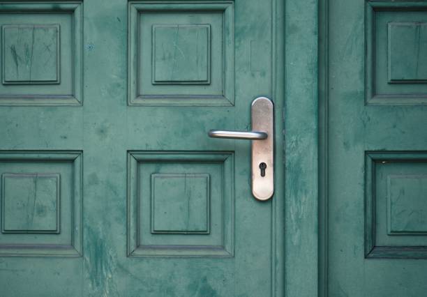 istock Green wooden door with a silver handle 1446843647