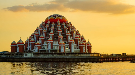 Makassar, Indonesia – September 25, 2019: The 99 Domes Mosque with the surrounding tranquil lake in Makassar, Indonesia