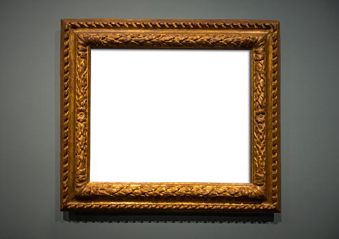 Blank gold frame isolated on grey background. Empty museum mockup