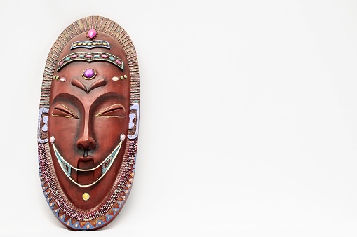A wooden African Mask on white background with copy space