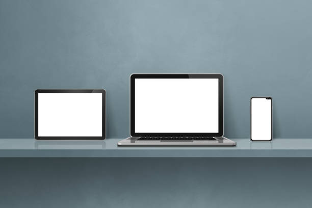 istock Laptop, mobile phone and digital tablet pc on grey wall shelf. Horizontal background 1446845976