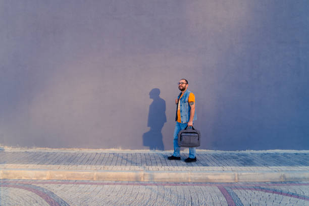 Young man going to work with his laptop bag. stock photo