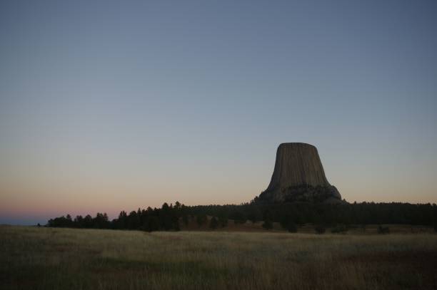 istock Mesmerizing Devils Rock surrounded by trees on a hill under the sky at twilight 1446846648