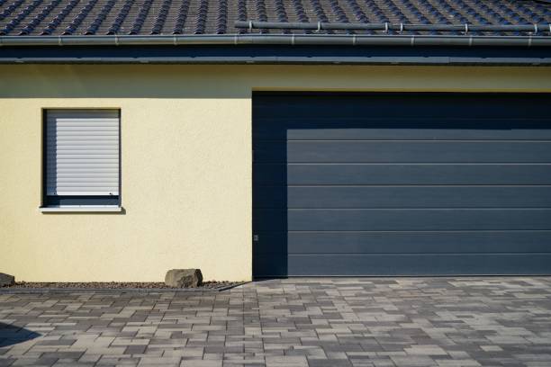 istock Small garage with a roller door and metal roofing on a sunny day 1446847537