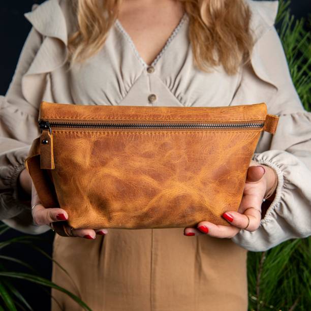 istock Handmade leather makeup bag on a woman's hands 1446848431