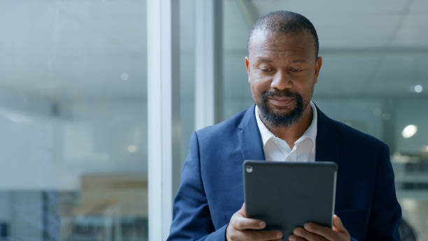 istock Black man, tablet and business technology for communication, planning and innovation with internet connection. African entrepreneur with mobile app for strategy, idea and work in corporate office 1446848681