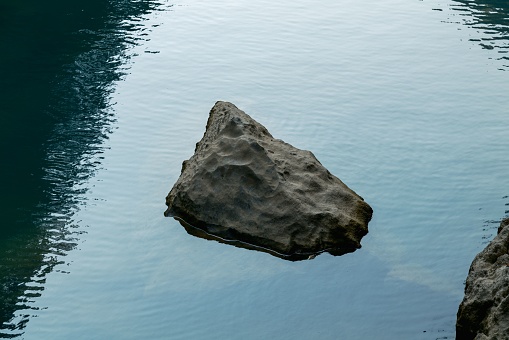 A beautiful shot of a rock in a lake in Guiyang, China