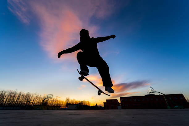 istock In the evening, a boy is playing skateboard. 1446850470