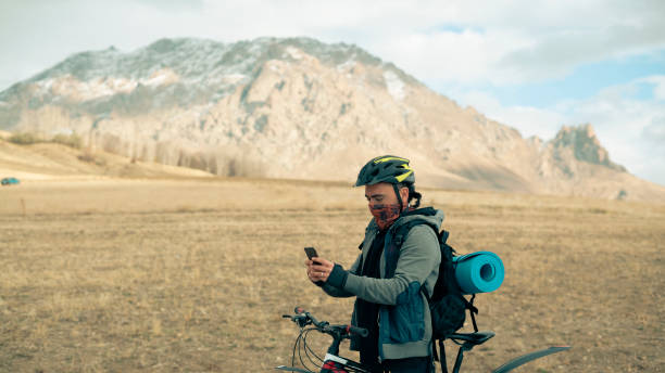istock Cyclist man taking a break and looking at his phone 1446850868