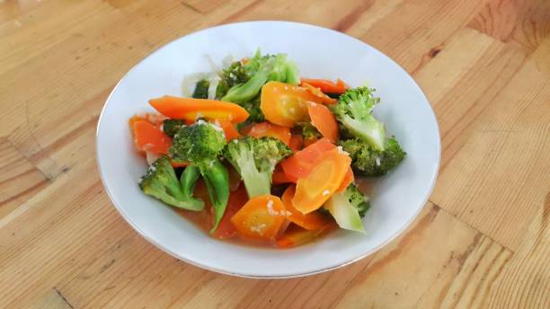 istock A bowl of cap cay vegetables on wooden table 1446856991