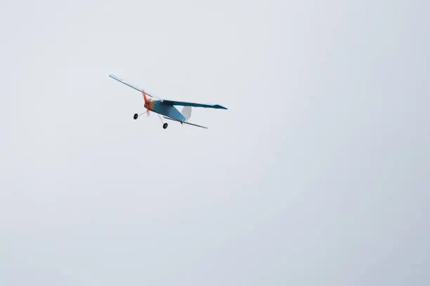 Photo of Radio-controlled model aircraft in the air makes a turn