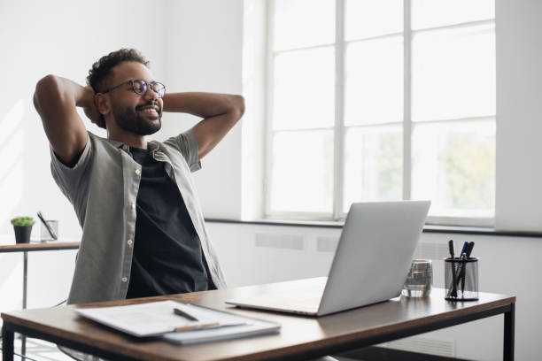 istock Relaxed young businessman resting in office 1446861614