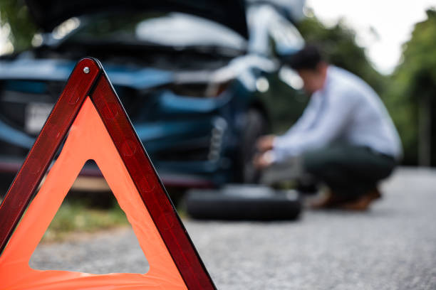 istock Asian businessman car broken has problems with wheel of his car 1446862588