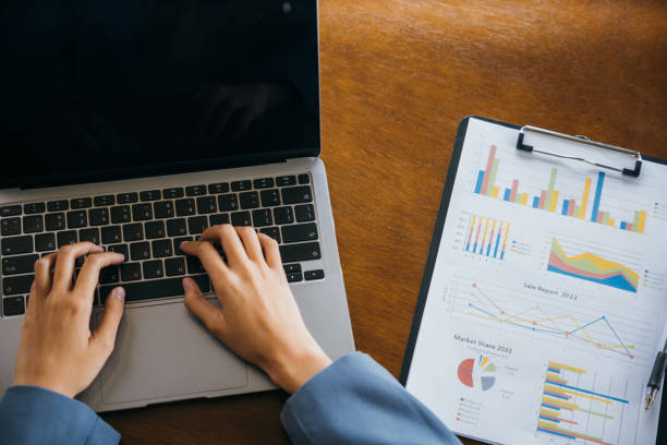 istock Professional business woman working on laptop computer with chart graphs and calculator 1446862681