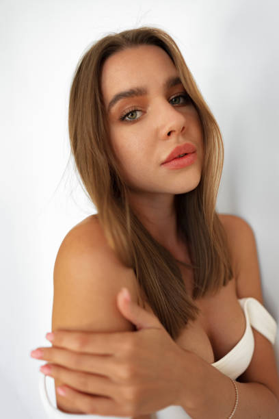 istock Beautiful attractive young woman with makeup posing in the studio on white 1446864719