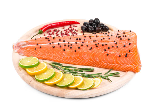 Salmon fillet with pepper and citrus. Isolated on a white background. Close-up.