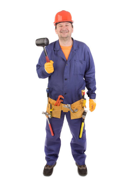istock A worker in a helmet holds a rubber mallet. 1446864879