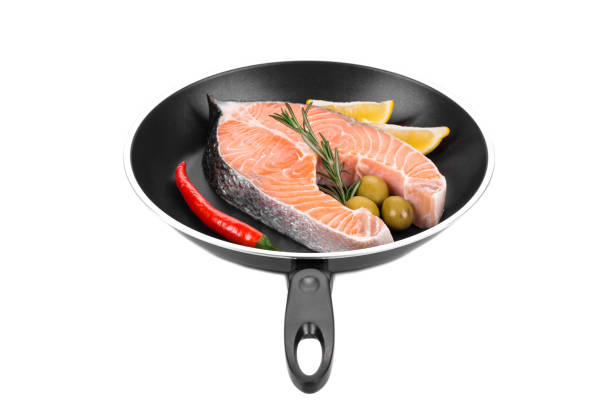 istock Salmon steak on non-stick frying pan. 1446864898