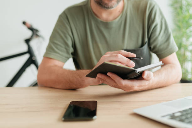 istock Telecommuter reading project paper notes in home office 1446867556