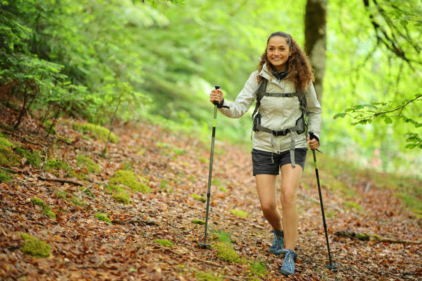 Happy hiker walking in a forest stock photo