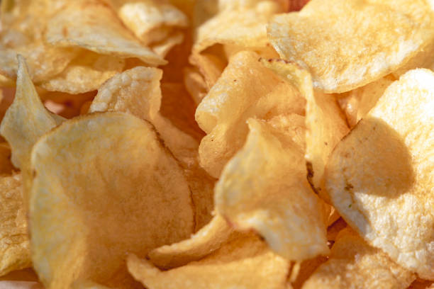 istock Crispy potato chips close up. Fast food. Selective focus 1446869146