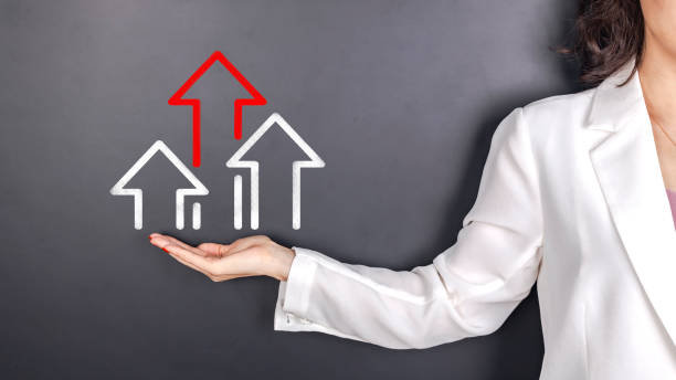 istock business woman showing growth arrow before blackboard 1446870547