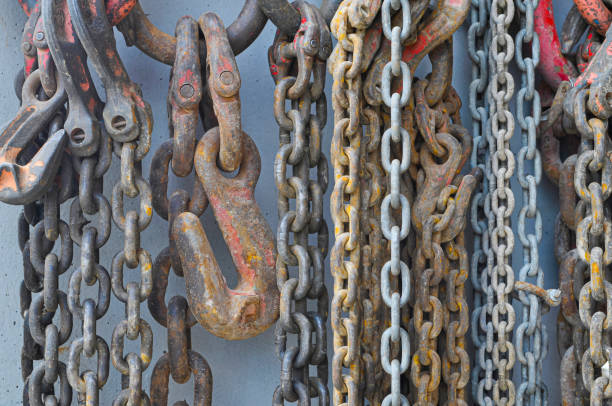 istock used chains hanging on cement wall inside a factory 1446870776