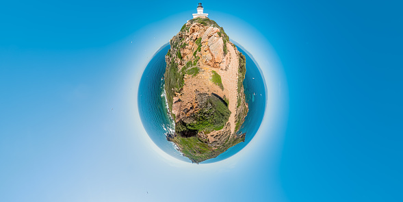 tiny planet of aerial 360 panoramic view of Sanguinaires islands of Corsica in France. Drone view of seascape and the lighthouse with the Genoese tower in Mediterranean sea and tourists.