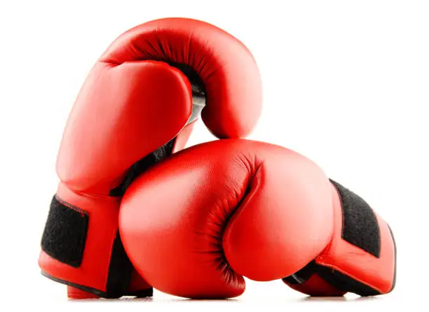 Photo of Pair of red leather boxing gloves isolated on white