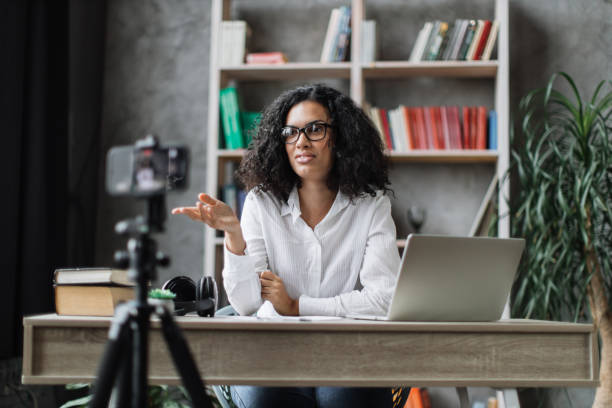 istock Multiracial woman vlogging in home office 1446873495