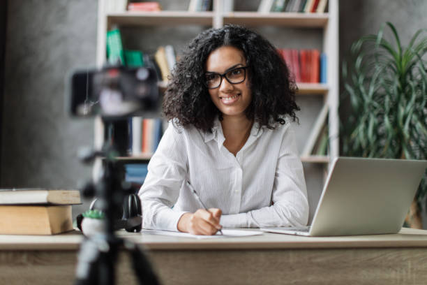 istock Multiracial woman vlogging in home office 1446873516
