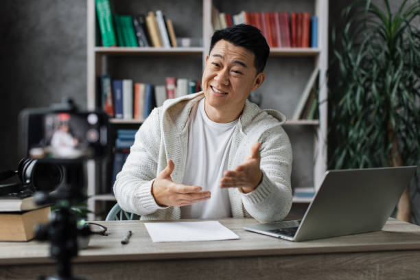istock Asian man vlogging in home office 1446873557