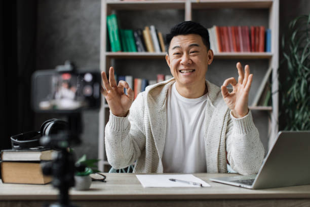 istock Asian man vlogging in home office 1446873565