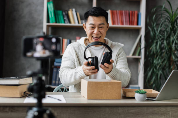 istock Asian man vlogging in home office 1446873643