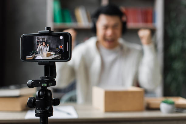 istock Asian man vlogging in home office 1446873659