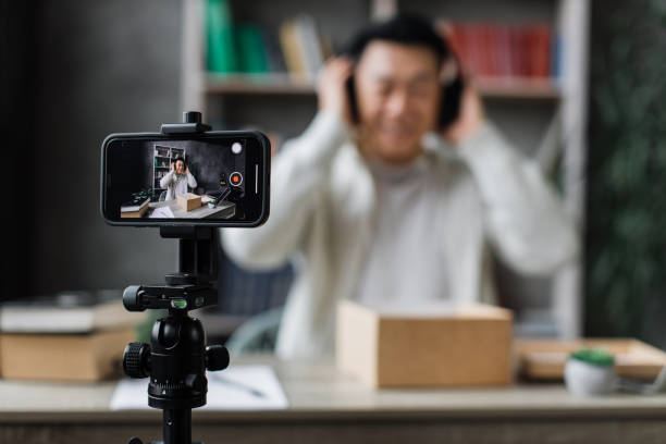 istock Asian man vlogging in home office 1446873671