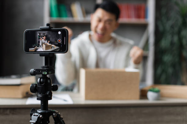 istock Asian man vlogging in home office 1446873693
