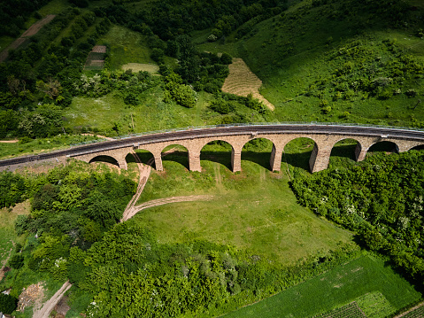 Aerial view of an old railway viaduct, Austro-Hungarian railway bridge in the village of Plebanivka in the Ternopil region of Ukraine, Travel sight points in Ukraine