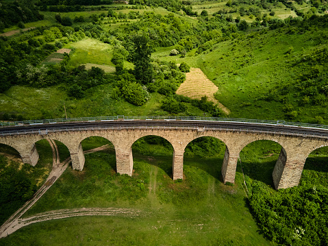 Aerial view of an old railway viaduct, Austro-Hungarian railway bridge in the village of Plebanivka in the Ternopil region of Ukraine, Travel sight points in Ukraine