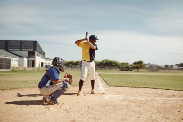 istock Baseball player, baseball team and man with bat on baseball field ready for training game, competition or match. Fitness, teamwork and baseball batter with team for sports workout outdoors on pitch. 1446873886