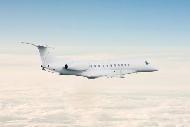 istock White luxury private jet flying in the air above the clouds 1446876694