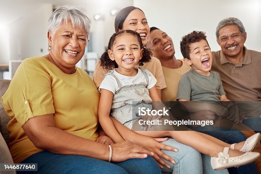 istock Grandparents, parents and children being happy, smile or laugh on sofa in living room for bonding, embrace or for loving. Family, mother or father with kids for happiness, together or on lounge couch 1446877640