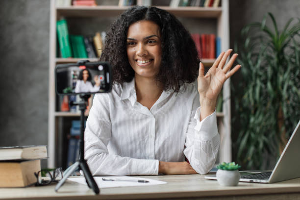 istock Charming multinational woman talking and gesturing while recording video on modern phone. 1446878622