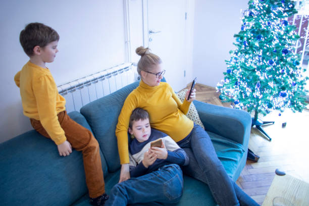 istock Mother and her two boys relax during Christmas 1446878994